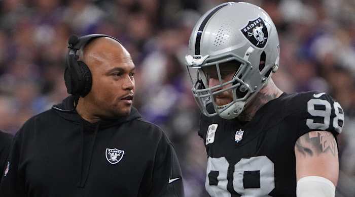 Las Vegas Raiders interim coach Antonio Pierce speaks to defensive end Maxx Crosby during their game against the Minnesota Vikings on Dec. 10, 2023.